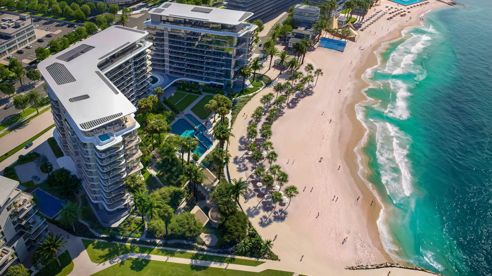 Bird’s-eye view of the two towers, their pools and gardens, and the palm-lined beach along the turquoise sea